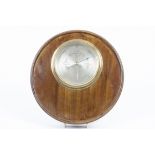 A mahogany circular wall barometer, brass cased steel dial, bevelled glass, 28 cm diameter