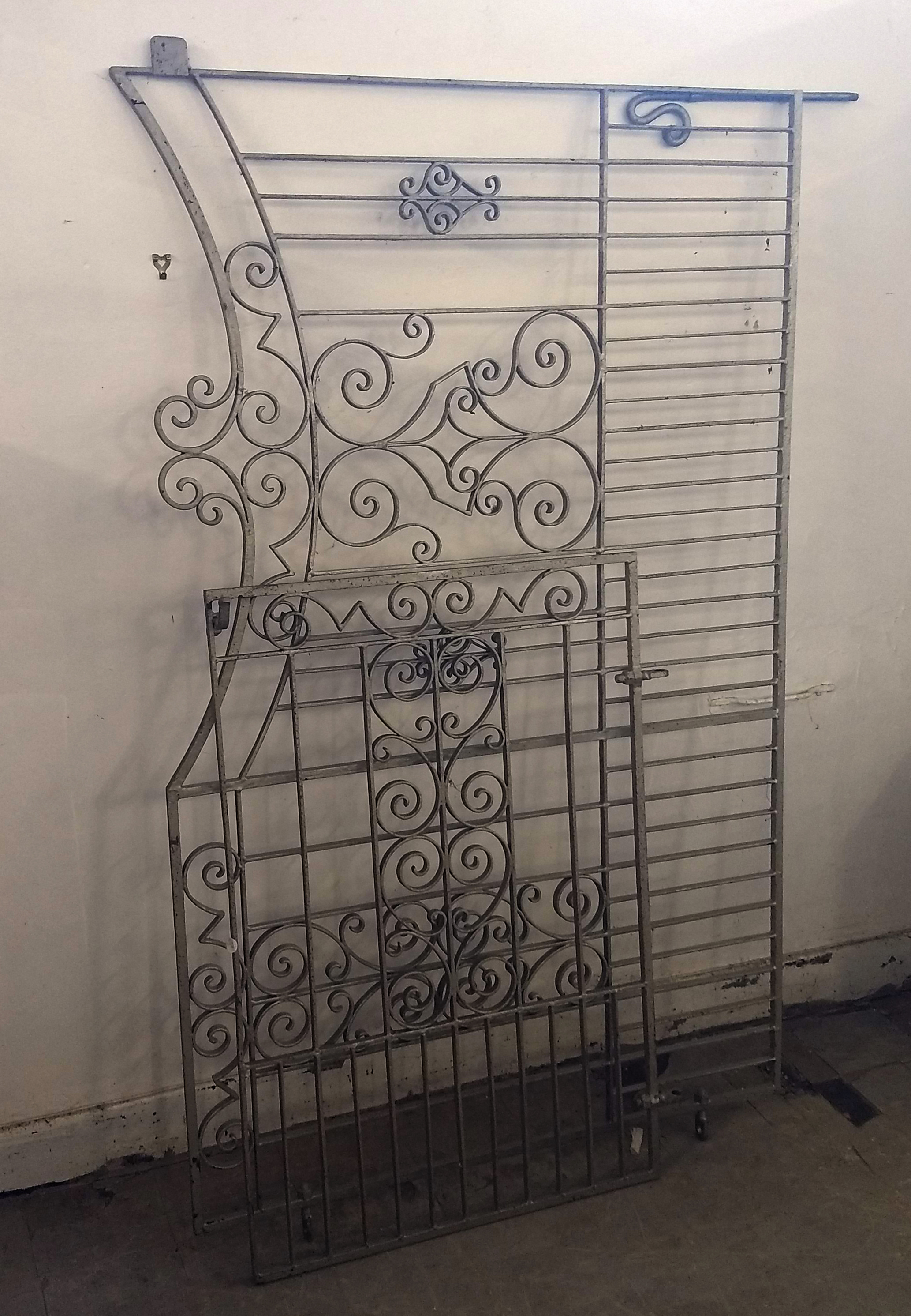 A pair of wrought iron gates, comprising one long and one short, scroll decoration, longest 190 cm