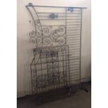 A pair of wrought iron gates, comprising one long and one short, scroll decoration, longest 190 cm