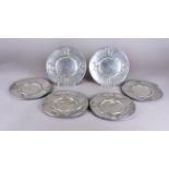 A set of six pewter Urania Art Nouveau plates, decorated with sinuous trees and stylised leaves,