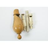 A group of four whistles, including three bone examples, one modelled as a dog's head, one missing