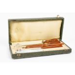 An early 20th Century cased pen set, amber Bakelite finish, comprising dip pen with George Hughes