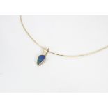 A modern 18ct gold opal and diamond pendant, the polished opal boulder in shaped mount set with