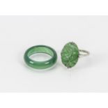 A vintage Chinese jade and white metal ring, together with a green hardstone band ring (2)