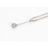 An early 20th Century 15ct gold and blue zircon pendant, presented on a white metal chain, 3.5g,