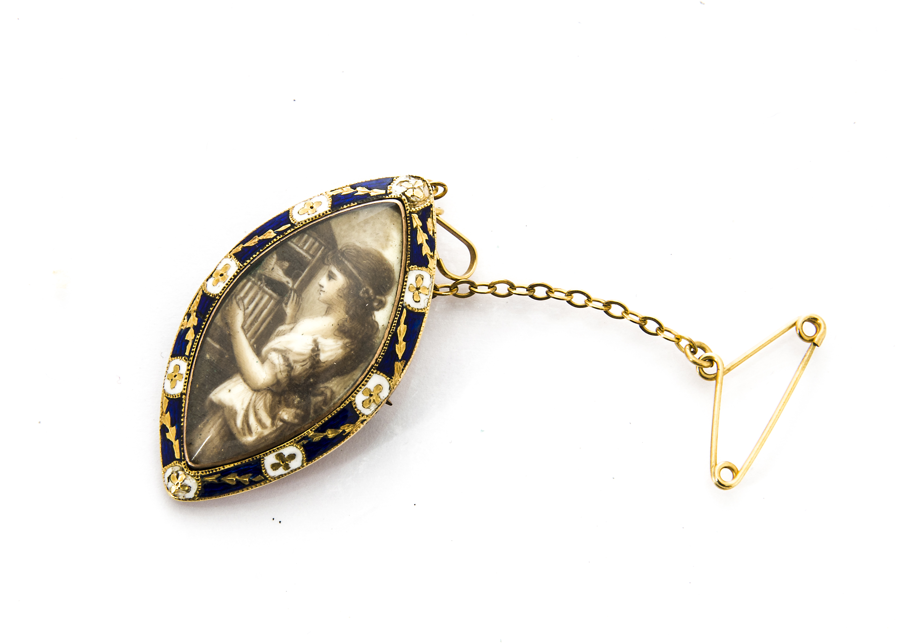 An early 19th Century gold and enamel navette shaped brooch, centred with painted miniature of young