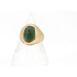 A vintage gold and emerald signet ring, the oval green stone, in need of repolishing in rubbed