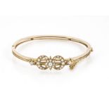 A Victorian gold and seed pearl bangle, having crescent and star design set with small white