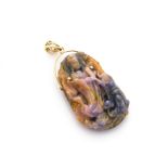 A Chinese fluorite carved gold set pendant, carved as an immortal standing in long robes within a