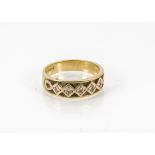 A modern 18ct gold and diamond ring, the tapered band with five brilliant cuts in zig zag setting,