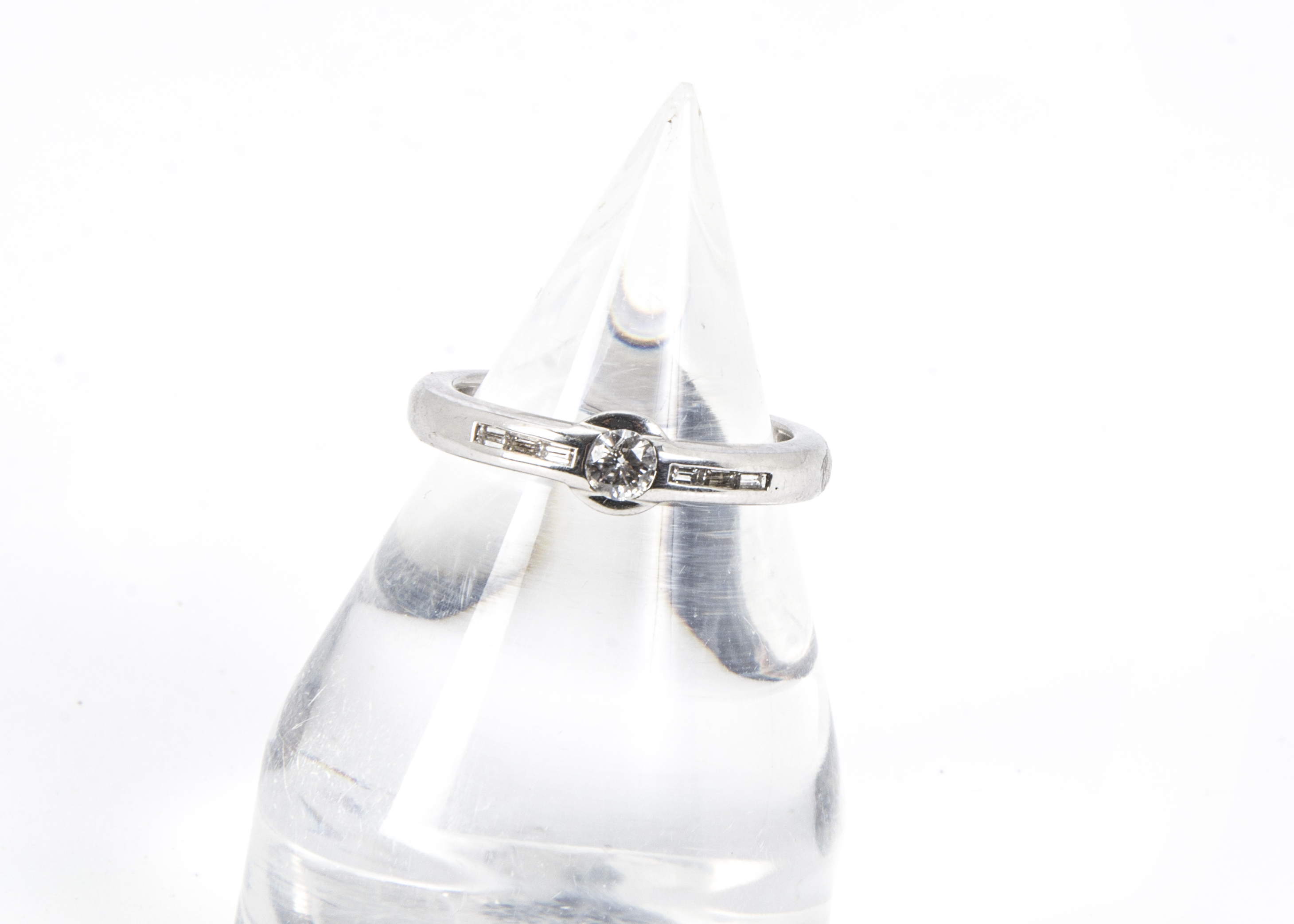 A modern 18ct white gold and diamond ring, having an approx 0.25ct old cut in rubbed over setting