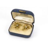 A pair of 1960s 18ct gold and diamond earrings, in the form of pierced flower heads and centred by a