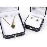 A modern 9ct gold and emerald pendant and earrings set, quatrefoil with four green stones and