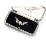 A pretty Victorian diamond set brooch, the gold and silver mount having central heart with wings and
