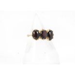 A vintage 18ct gold and three stone garnet ring, marked 750, 5g and size N, with T.H. Garlick & Co