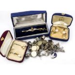 A collection of jewellery, including three charm bracelets and a coin example, an RAF sweetheart