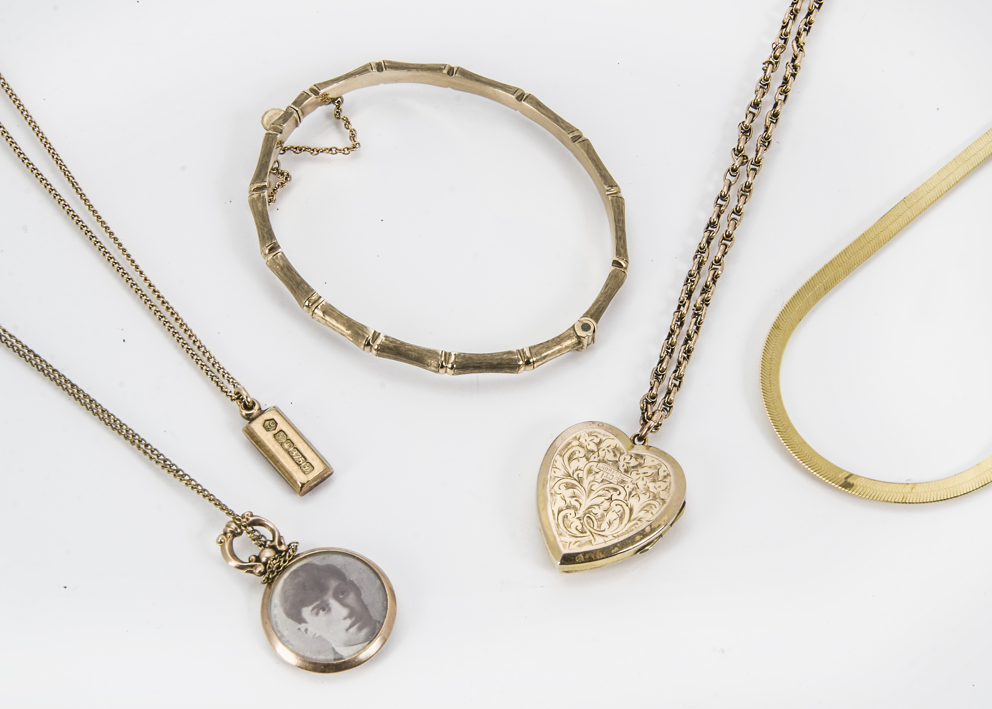 Five vintage and modern items of gold jewellery, including a bamboo bangle, a gold front and back