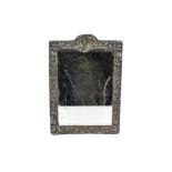 A late Victorian silver framed dressing table mirror by William Comyns, rectangular form decorated