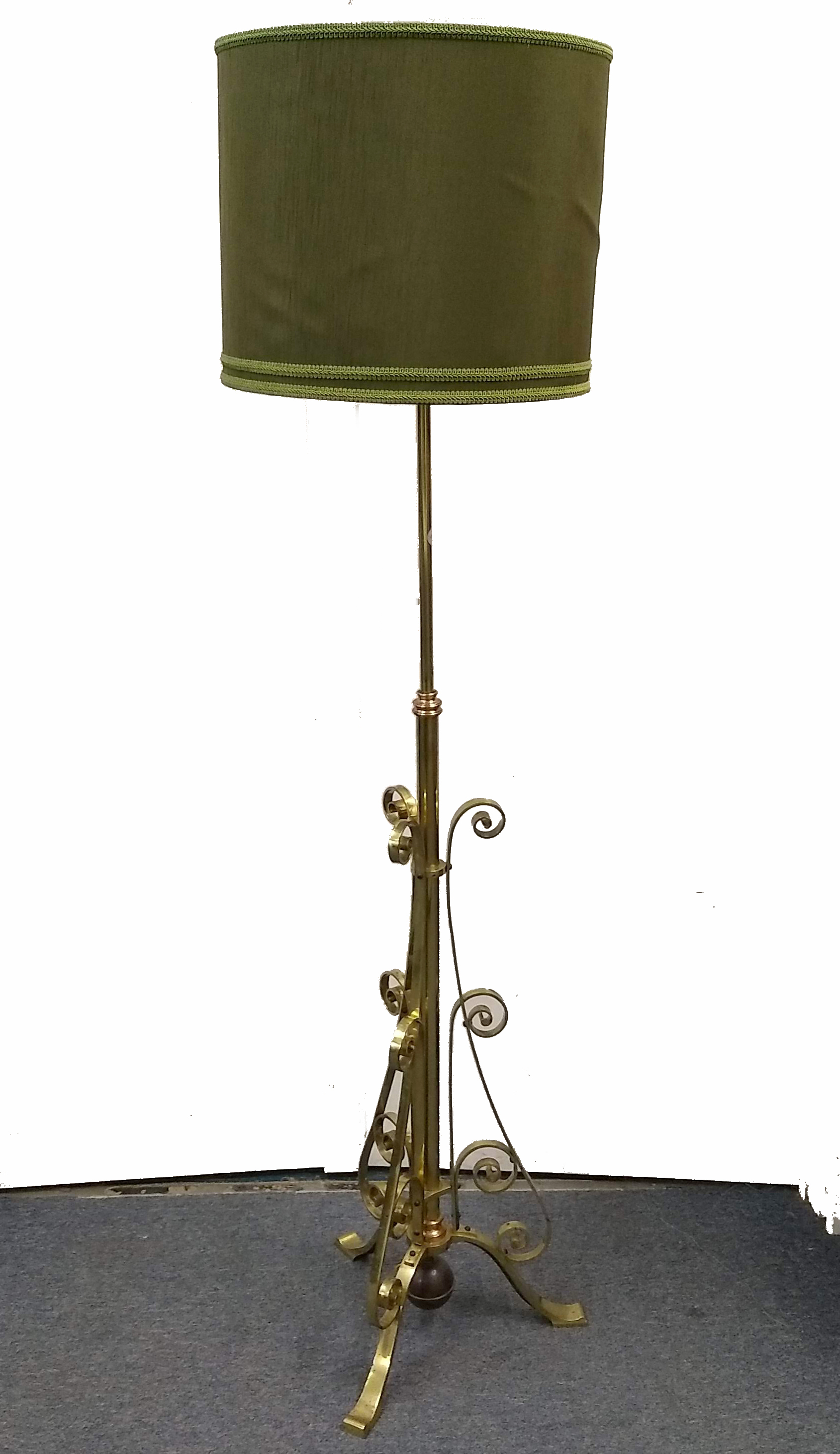 A brass and copper mounted standard lamp, scroll decorated, weighted base with three splayed