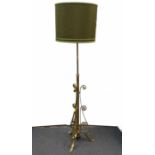 A brass and copper mounted standard lamp, scroll decorated, weighted base with three splayed