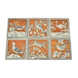 A set of six Minton & Hollins dust pressed tiles, black and white designs of birds on brown ground