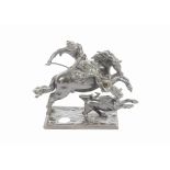 A bronze model of St George fighting the dragon, on horseback, dressed in armour and holding a