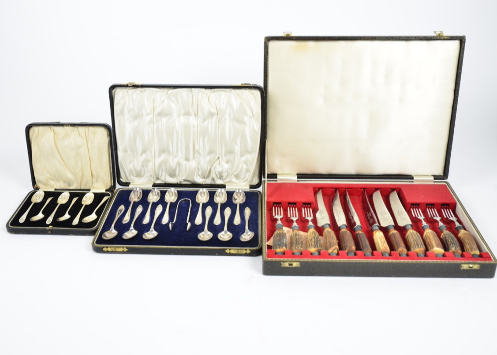 A large quantity of silver plated cutlery, including teaspoons, carving sets, knives and forks, with