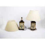 A pair of lamp bases, the metal bodies decorated with floral prints, the upper ceramic section