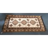 A mid 20th Century Kurdish rug, cream field with three large brown central hooked medallions and