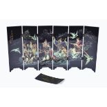 A modern Chinese lacquered folding table screen depicting the Eight Immortals crossing the sea,