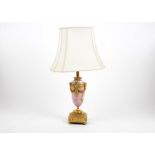 A French porcelain and ormolu mounted table lamp, baluster form decorated with floral and cherub