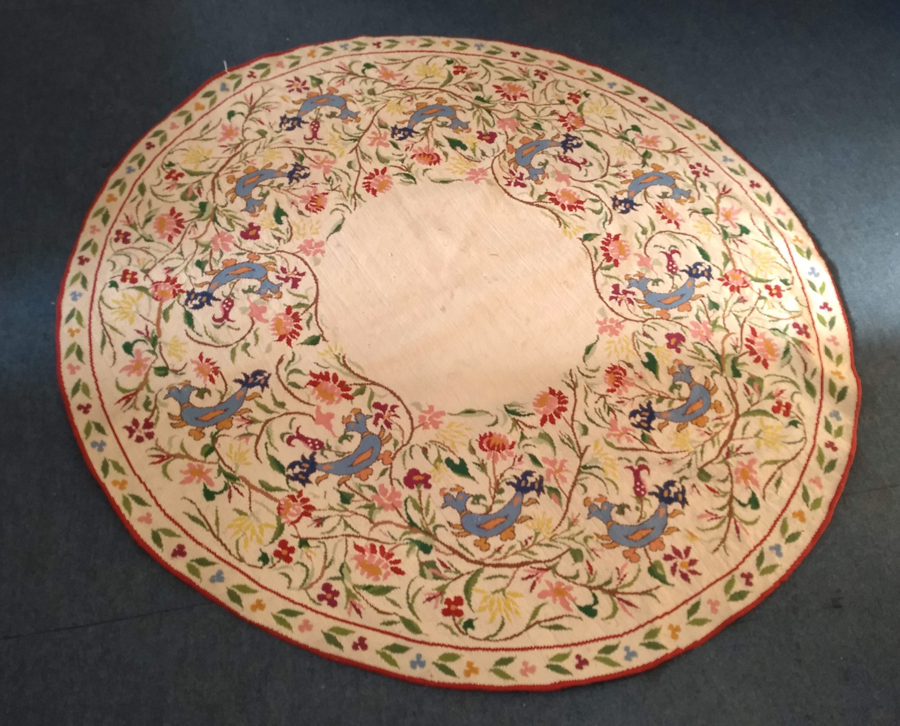 A 20th Century Greek woollen circular rug, floral and bird decoration on cream ground, 'National