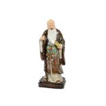 A 20th Century Chinese porcelain figure of a scholar, holding a scroll and staff (missing top of