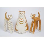 Three ginger cat figures, a seated fat feline, 42 cm high, together with two smaller standing