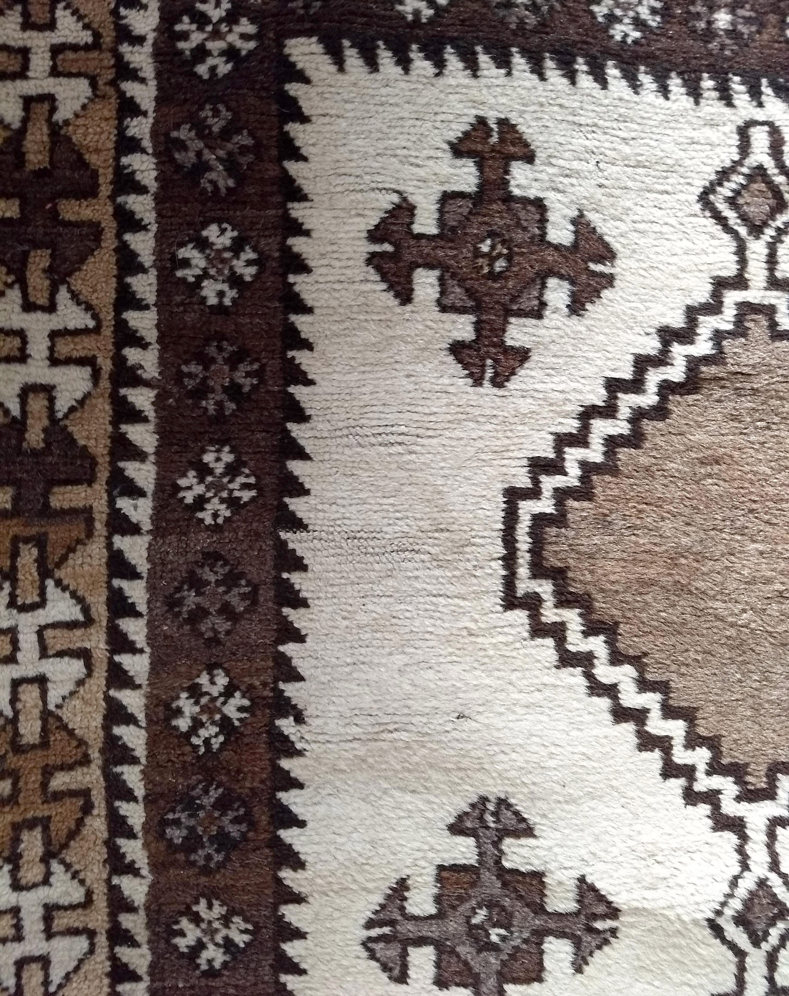 A mid 20th Century Kurdish rug, cream field with three large brown central hooked medallions and - Image 3 of 4