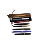 A collection of 20th Century pens, including a Waterman taperite pen, a Waterman pencil, two