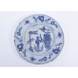 An 18th Century Delft blue and white dish, decorated with a man flanked by a flag and a large tureen
