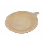 A 19th or 20th century large stone pan, the interior smooth whilst the exterior remains rough, 55 cm