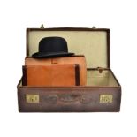 A Dunn & Co. vintage bowler hat, together with a leather suitcase, briefcase and an Italian