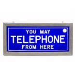 A rectangular enamel sign inscribed 'You may telephone from here', in white lettering on dark blue