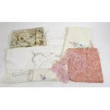 A large collection of textiles, tablecloths, place mats, doilies, handkerchiefs and more, some