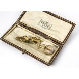 A late 19th Century gold and diamond stick pin, the rough cut diamonds in channel setting surrounded