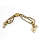 A Victorian gold lapel fob chain, with engraved lozenge decoration supporting two 9ct gold padlock