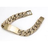 A 9ct gold flattened curb linked gentleman's identity bracelet, with tooled decoration to each link,