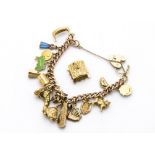 A vintage 9ct gold charm bracelet, curb link chain with multiple charms, 47.7g, together with a