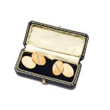 A pair of 1980s 9ct gold and diamond cufflinks, oval panels joined by chains, one panel set with