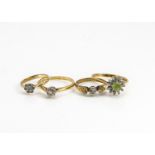 Four contemporary 18ct gold gem set dress rings, three diamond examples, and a peridot and diamond