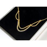 An 18ct gold sapphire set fringe necklace, the textured baton links supporting stylised flowers