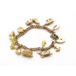 A vintage and modern 9ct gold charm bracelet, the curb link chain probably from a watch chain