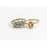 A 9ct gold three stone zircon dress ring, the oval mixed cuts in claw settings, ring size L together